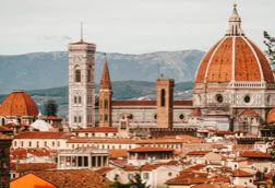 View of Florence with the Florence Cathedral and its iconic dome in the foreground.