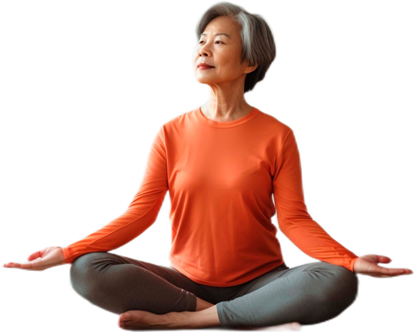 A person with short gray hair sits cross-legged on the floor, wearing an orange long-sleeve shirt and gray pants, with eyes closed and hands resting on knees.